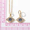 Gold Tone Crystal Evil Eye Necklace and Huggie Earring Options view 4