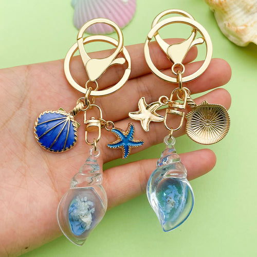 Image 1 showing starfish, conch and shell keychains shown in the product image.