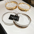 Wide Polished Hoop Earrings In Gold And Silver With Decorative Details view 2
