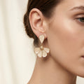 White Translucent Four Petal Gold Tone Dangle Earrings view 1