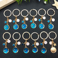 Six Blue Zodiac Moon and Star Metal Keychain Designs view 2