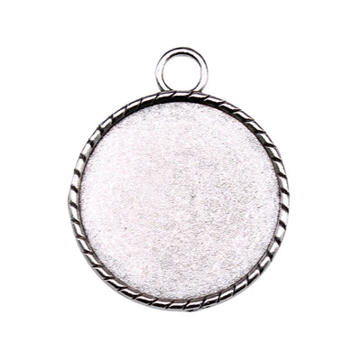 Close view of round bezel pendant trays in two antique metal finishes