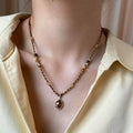 Brown And Gold Tone Beaded Necklace With Dark Round Pendant view 3
