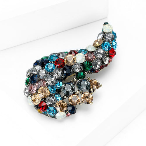 Paisley multicolor rhinestone brooch angled on white blocks