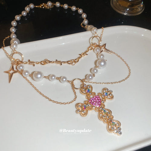 Close view of the colors and surface details on crystal cross pearl layered necklace
