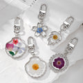 Silver Tone Shell and Floral Pressed Flower Clip Keychains view 1