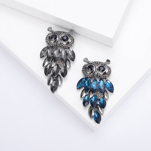 Gray and blue marquise crystal owl brooches on white