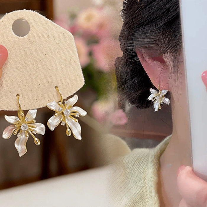 White Floral Drop Earrings with Gold Tone Petal Accents