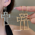 Open Cross Hoop Earrings in Gold and Silver with Polished Metal Details view 1