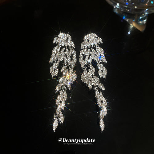 Second listing image of silver crystal leaf chandelier earrings, showing the visible finish.