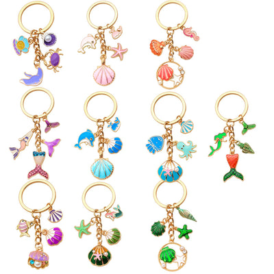 Catalog view of the pictured nine colorful ocean animal and mermaid metal keychain on a light background