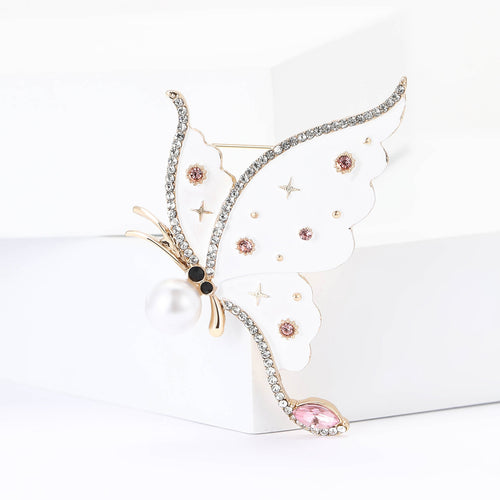 White enamel star butterfly brooch with pearl body and pink crystal tail
