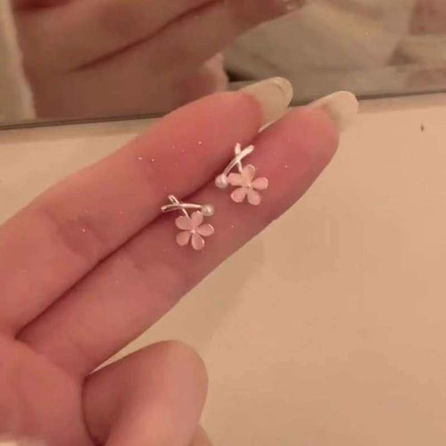 Primary view of small five-petal pink flowers on slim silver tone posts with pale central accents