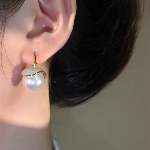 A display view of the double bead pearl look earrings.