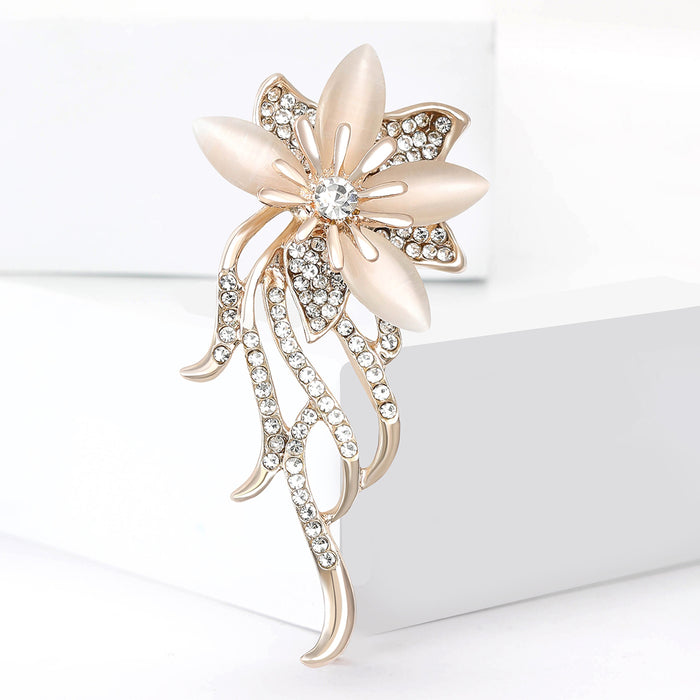 Crystal Floral Spray Brooch With Polished Metal And Sculpted Decorative Details