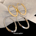 Slim Elongated Oval Hoop Earrings in Gold and Silver Tones view 3