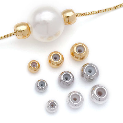 Front overview of silicone lined stopper beads with optional loops arranged by finish and size