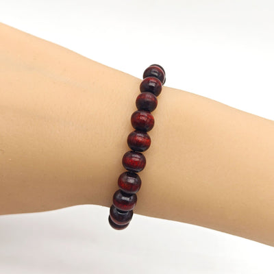 Reddish brown wood bead bracelet worn on a mannequin wrist