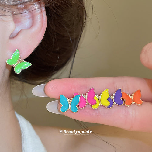 Small enamel butterfly studs and silver tone starfish-shaped studs displayed in a close product arrangement.