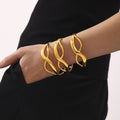 Figure Eight Curve Clasp Bangles Polished Gold and Steel Tone view 4