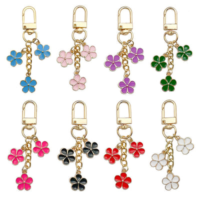 Image 5 showing a set of four different colored flower charms.