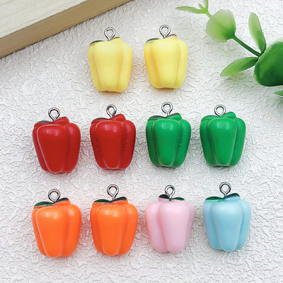 Multicolor chili pepper charms arranged on a light background