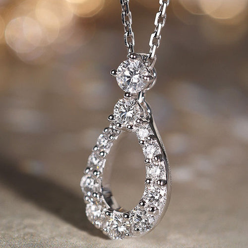 Front product view of the open teardrop pendant outlined with clear accents