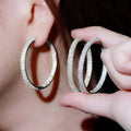 Large Oval Pave Hoop Earrings In Gold And Silver Tones view 5