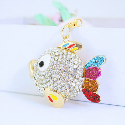 Front view of a fish charm covered in clear rhinestones with a multicolor tail.