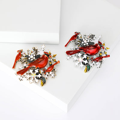 Front view of two red cardinals perched among crystal branches