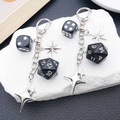 Main display of black polyhedral dice and four point star clasp keychain