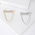 Crystal Bow Chain Brooch In Gold Or Silver Tone With Polished Metal Detail view 1