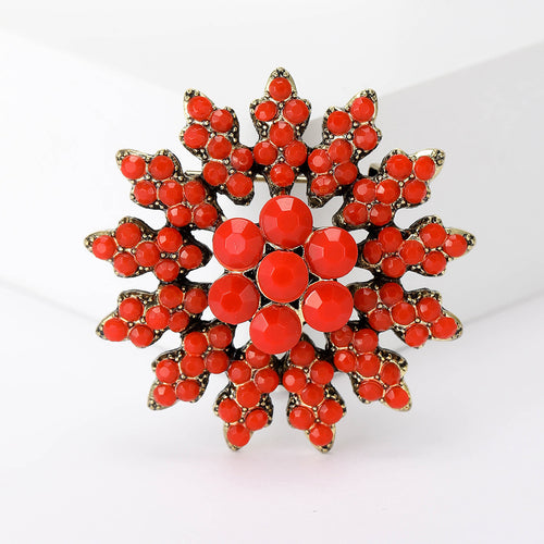 Red baroque snowflake cabochon brooch close-up antique gold tone