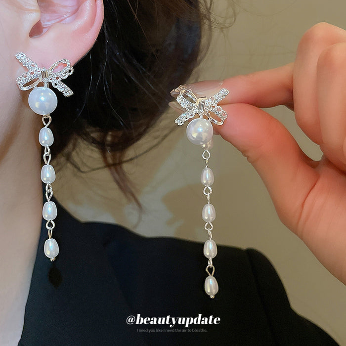 Crystal Bow Pearl Tassel Earrings With Polished Metal Tone Details