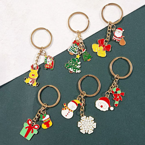 Assorted enamel Christmas keychains including reindeer sleigh trees bells and gift stocking