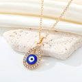 Gold Tone Crystal Teardrop Evil Eye Necklace and Huggie Earrings view 3