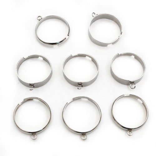 Grouped detail view of open stainless steel ring components with a small welded attachment loop