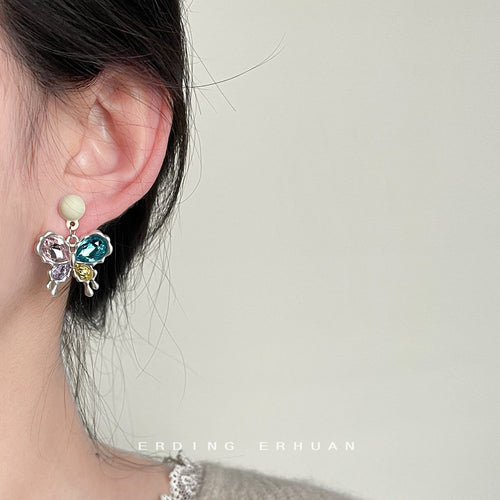 Colorful butterfly crystal earring worn on ear profile
