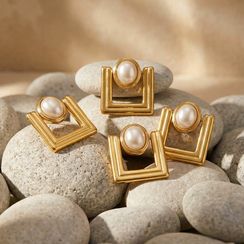 On-ear view of gold tone geometric square pearl center earrings in main image 2.