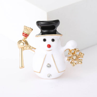 White enamel snowman brooch with black hat broom and gold snowflake
