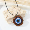 Wood Scalloped Round Blue Evil Eye Pendant Necklace on Black Cord view 3