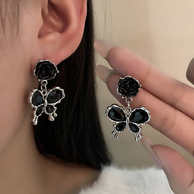 Primary supplied view of black rose butterfly dangle earrings