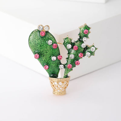 Green Cactus brooch styles arranged on a light display