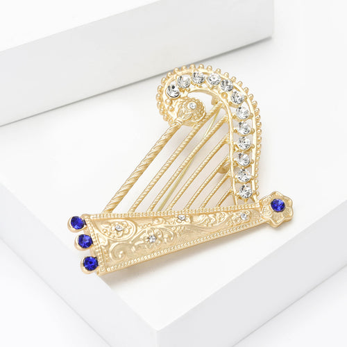 Ornate crystal-set harp with blue accents brooch styled display