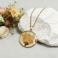Gold Tone Round Pressed Flower Pendant Necklaces in Fourteen Designs view 8