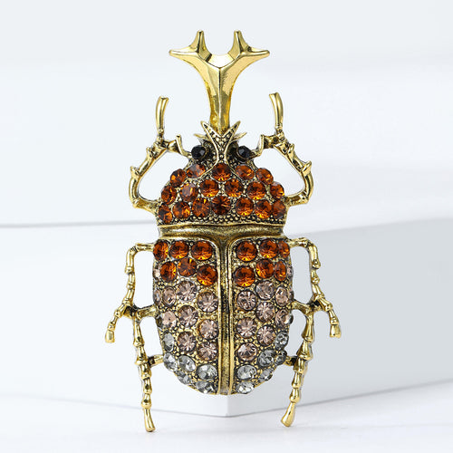 Crystal Beetle brooch In Black And Antique Gold Decorative Lapel Pin shown in styled product arrangement