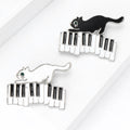 Enamel Cat on Piano Keyboard Brooch Black and White view 3