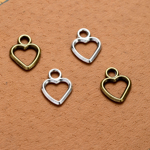 Second product image of the open heart outline charm showing a small open heart outline with a rounded top loop