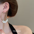 Gold Tone Hoop Earrings With White Floral and Pearl Like Accents view 3