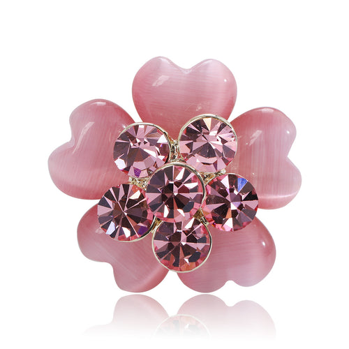 Pink cat-eye petal flower brooch with rhinestone center on white